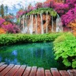 Beautiful wooden path trail for nature trekking with lakes and waterfall landscape in Plitvice Lakes National Park, UNESCO natural world heritage and famous travel destination of Croatia.