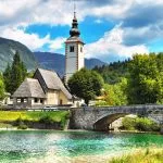 Bohinj Lake, Church of St John the Baptist with bridge. Triglav National Park, Julian Alps, Slovenia.