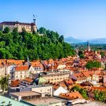 Old town and the medieval Ljubljana castle on top of a forest hill in Ljubljana, Slovenia